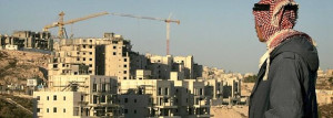 A Palestinian man looks at a construction site of new housing units in the Israeli neighborhood of Har Homa in east Jerusalem, Thursday, Dec. 27, 2007. At their first summit since pledging to renew peace talks and try for a treaty next year, Israeli and Palestinian leaders faced a familiar obstacle on Thursday, Israeli construction in a disputed part of Jerusalem. (AP Photo/Sebastian Scheiner)